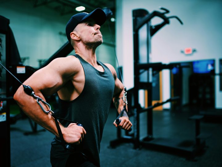 Gordon Cowie working out at the gym doing a cable fly